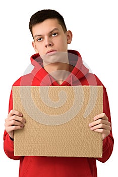 Bored exhausted teenage boy holding blank brown cardboard banner, tired of problems. Young guy feeling upset