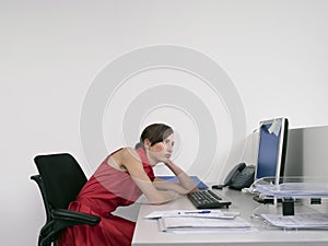 Bored Female Office Worker At Desk