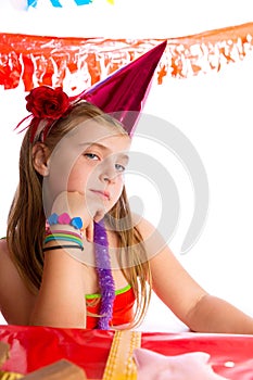 Bored gesture blond kid girl in party birthday hat