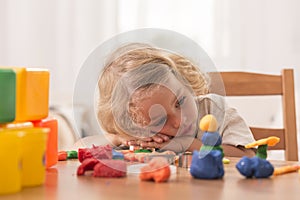 Bored girl with plasticine toys photo