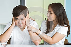 Bored husband closed his ears with hands do not want to listening voice of anger wife