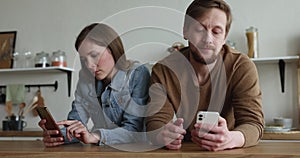 Bored ignoring silent gadget addicted couple using smartphones