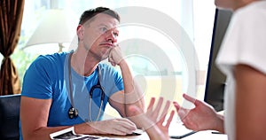 Bored indifferent doctor listens to patient concept