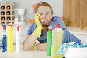 bored man holding cleaning product