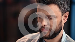 Bored man watching TV at home in evening, closeup portrait of single man, sad and sorrowful emotions