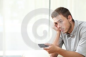 Bored man watching tv and zapping