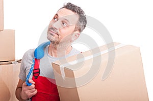 Bored mover guy holding box and telephone receiver