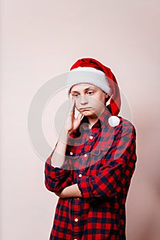 Bored and pensive kid in christmas hat