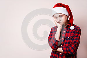 Bored and pensive kid in christmas hat