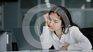 Bored sad lazy young indian woman manager sitting in office unmotivated uninterested in boring laptop work overworked