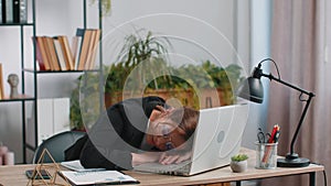 Bored sleepy business woman worker working on laptop computer, yawning falling asleep at home office