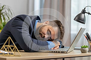 Bored sleepy Caucasian business man worker working on laptop computer, falling asleep at home office