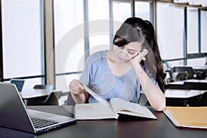 Bored student is studying in the classroom