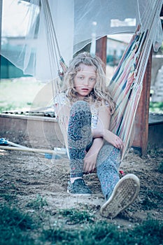 bored teenage girl in hammock swing