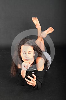 Bored teenage schoolgirl playing with smartphone