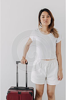 Bored and tired face woman in her private loungewear and baggage isolated on white.