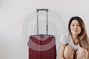 Bored and tired face woman in her private loungewear and baggage isolated on white. photo
