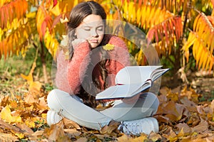 Bored and tired. Little child enjoy learning at backyard or park. Kid study with book. Self education concept. Child