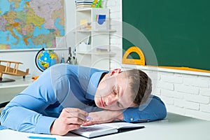 Bored and tired sleeping students in classroom. Demotivated boring students sitting in a lecture in college.