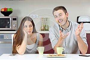 Bored wife hearing her husband talking photo
