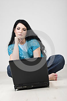 Bored woman browsing on a laptop