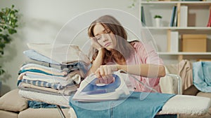 Bored Woman Housewife Ironing Clothes at Home.