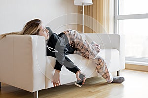 Bored woman lying in sofa