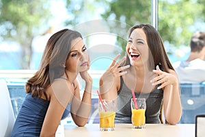 Bored woman suffering a bad conversation from a friend