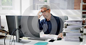 Bored Workaholic Businessman At Office Desk