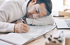 Bored, writing and diary with a business man lying on his desk at work while making note of an appointment. Schedule