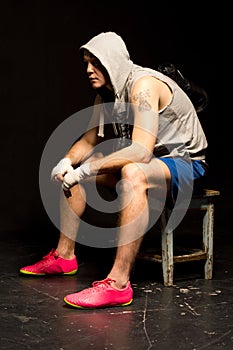 Bored young boxer waiting for his match