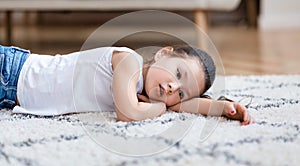 Boredom. Bored Asian Girl Lying On Floor At Home, Panorama