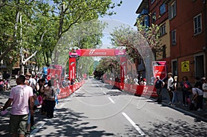 People stand along street waiting for peloton of cyclists of Giro d`Italia
