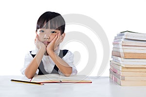 Boring Asian Chinese little girl wearing school uniform studying