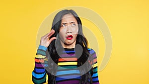 Boring asian woman showing bla-bla-bla gesture with hands looking to camera