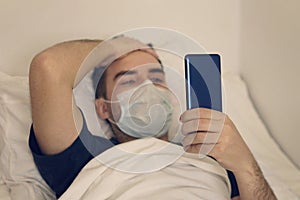 Boring patient using smartphone while resting in hospital bed. sick patient admit to hospital for medical treatment