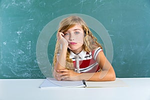 Boring sad expression student schoolgirl on desk