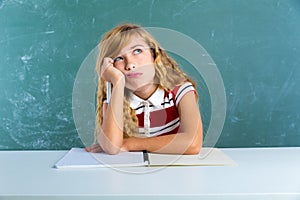 Boring sad expression student schoolgirl on desk