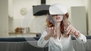 Boring woman in vr glasses. Smiling girl playing 3d interactivity