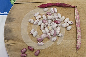 Borlotti beans peeled on wooden cutting board