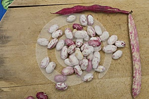 Borlotti beans peeled on wooden cutting board