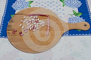 Borlotti beans peeled on wooden cutting board