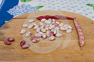 Borlotti beans peeled on wooden cutting board