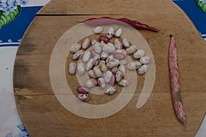 Borlotti beans peeled on wooden cutting board