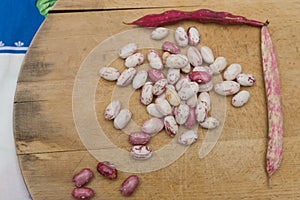 Borlotti beans peeled on wooden cutting board