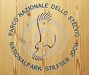 BORMIO, IT - JUNE 2018: Stelvio national park logo encarved in a wooden surface