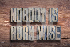 Born wise proverb wood photo