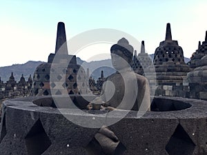 Borobudur Buddhist temple with Merapi mountain at the background .Near Yogyakarta on Java Island, Indonesia photo