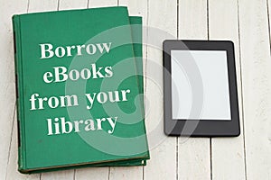 Borrow ebooks from the public library with retro old green book and ereader photo