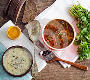 Borsch and mushroom soup served on table